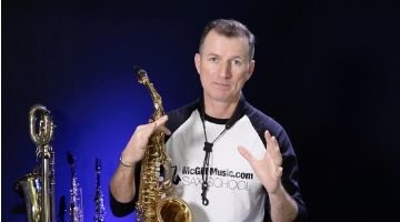 Nigel McGill holding his saxophone