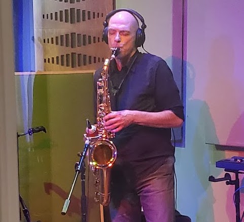 Sax School member Charles making studio recording on saxophone with Some Ska Band