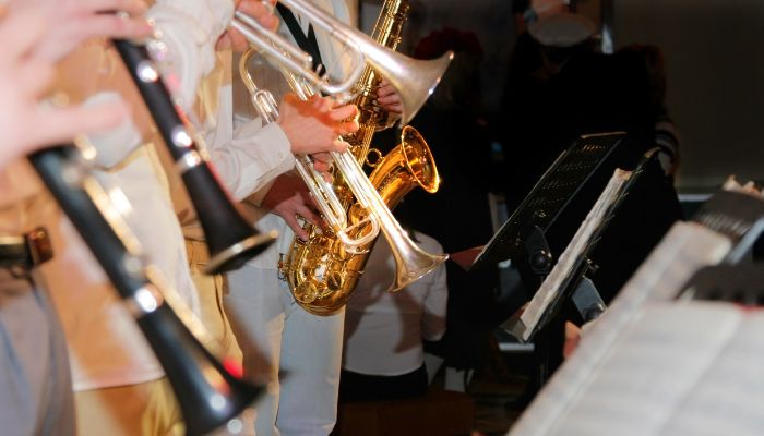playing saxophone in a community band playing sax in a concert band